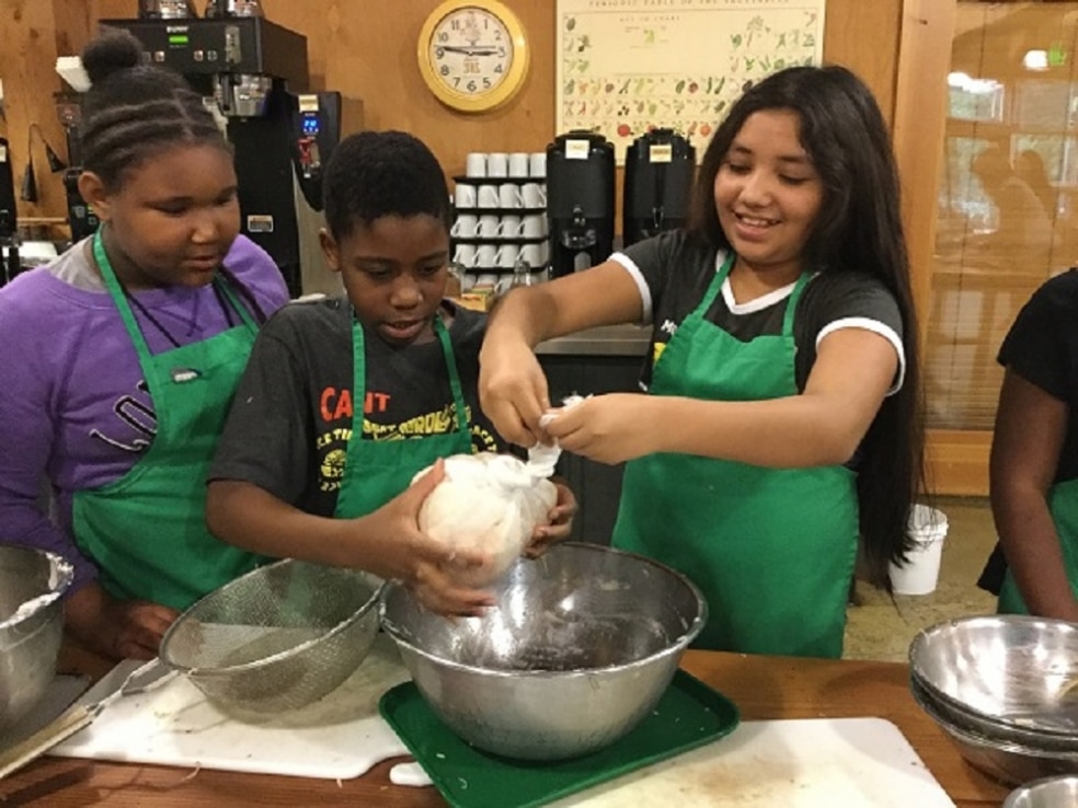 School Overnight Program students cook in the Dining Hall.