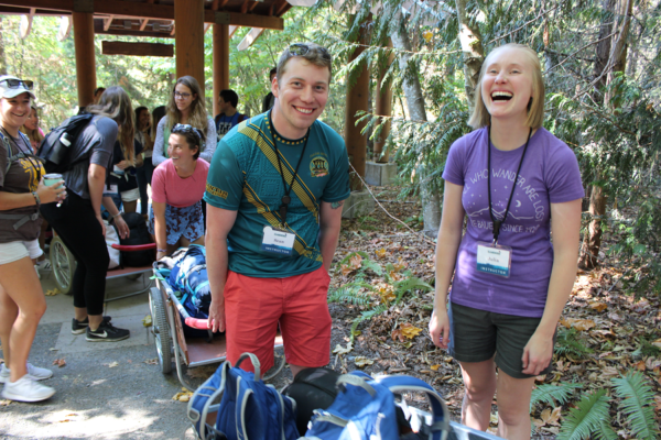 IslandWood Graduate Program students laugh outside the Arrival Shelter.