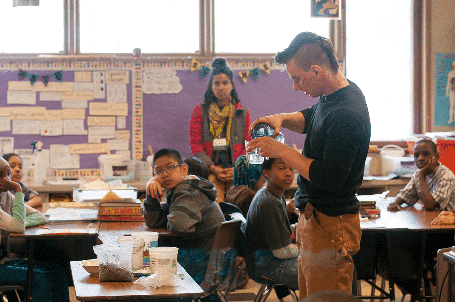 A teacher leads a science investigation in a classroom while students watch. Environmental Education Professional Development