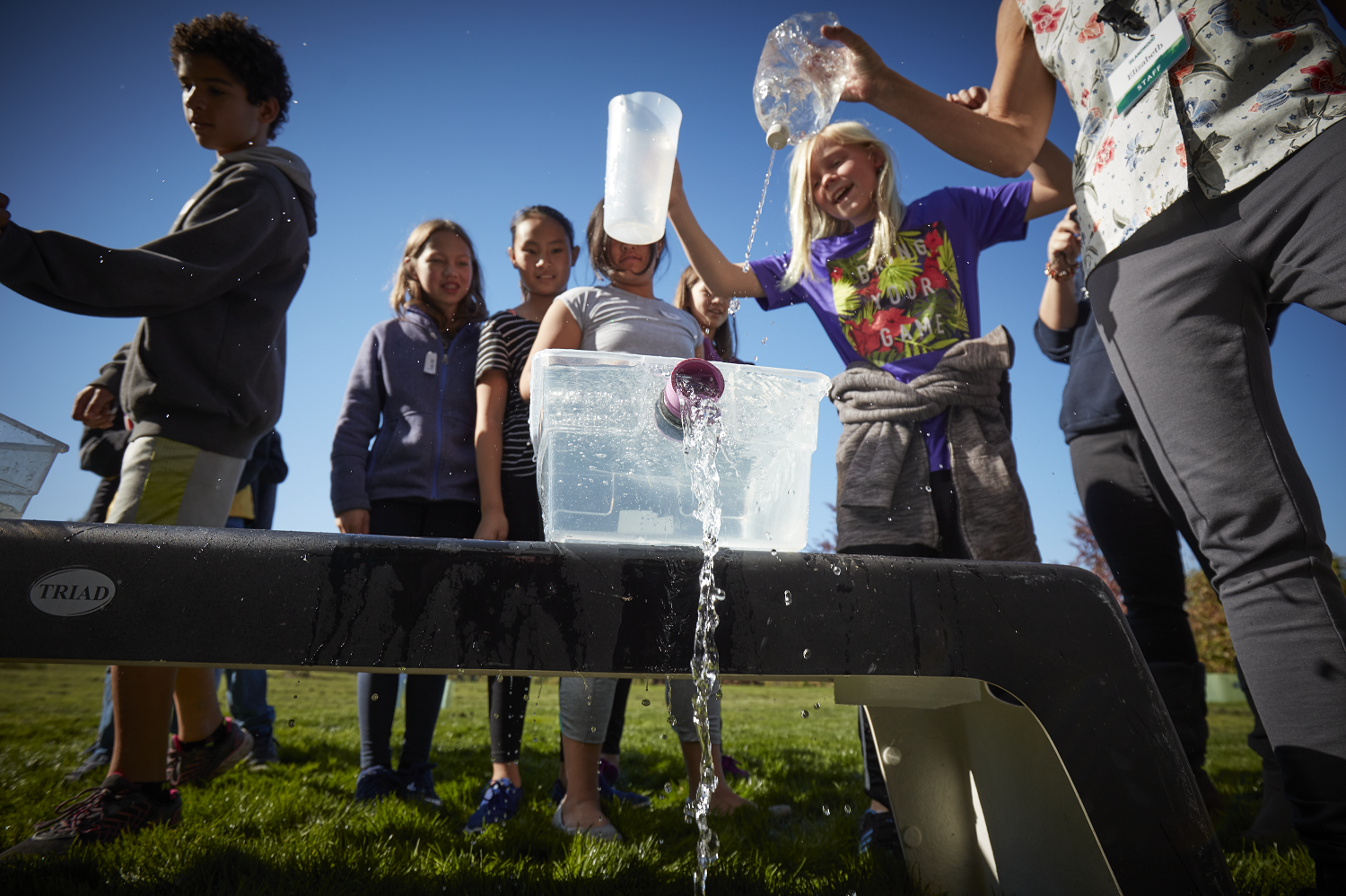Students work together during a relay activity modeling stormwater levels during a Brightwater Treatment Center day program.