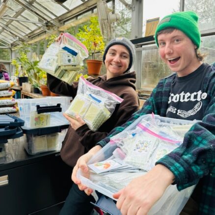 IW grads Sam and Finn share newly organized seeds, ready for 2024 growing season